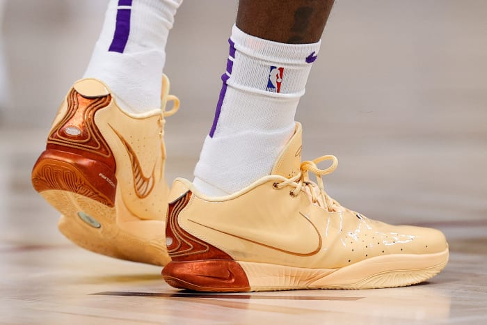 Side view of Los Angeles Lakers forward LeBron James' orange Nike sneakers.